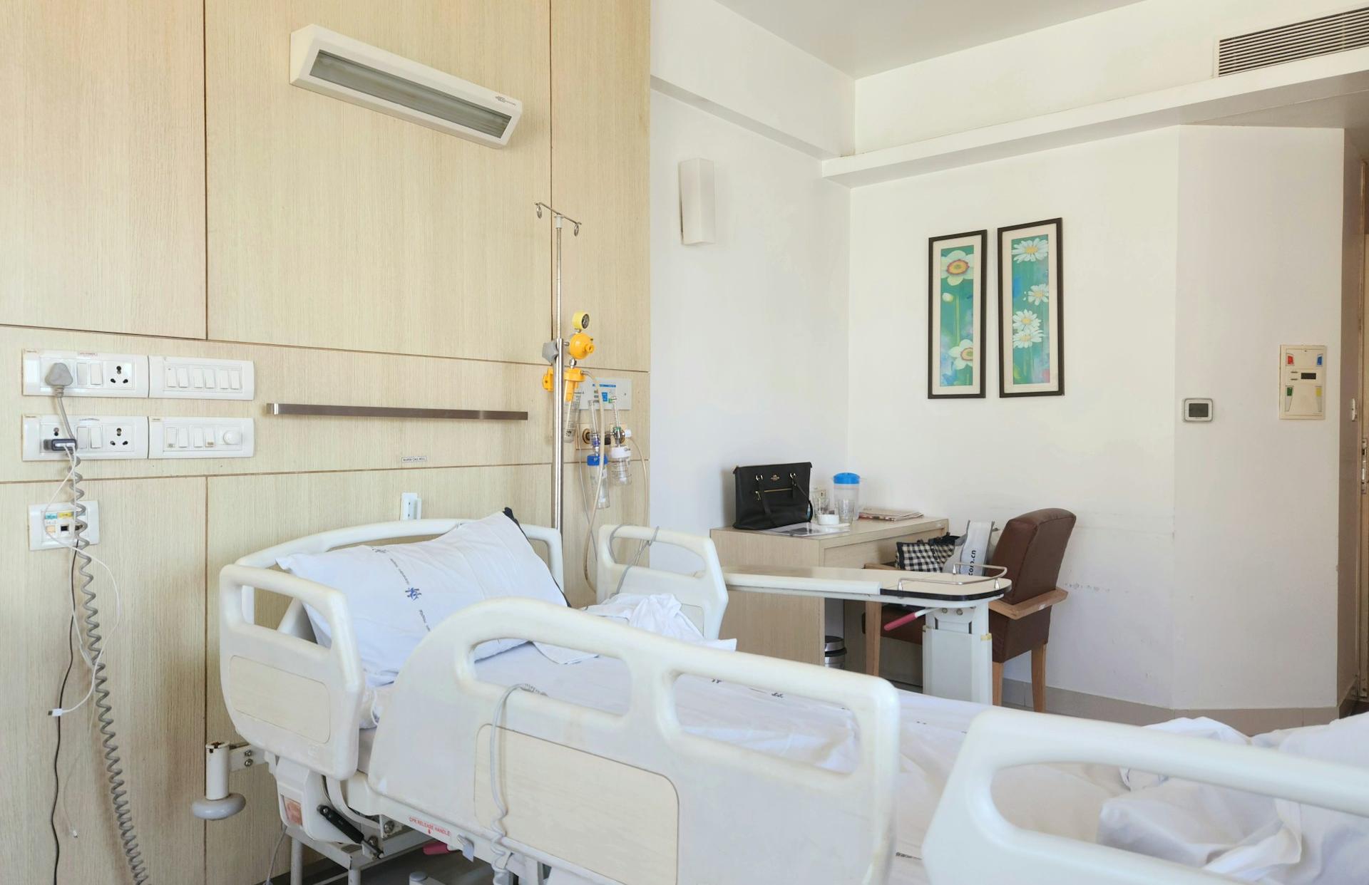 a hospital room with a bed and a desk